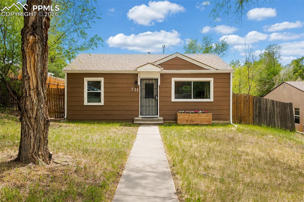 Image 1 of 24: Brown siding exterior with white trim, a concrete walkway, and a decorative