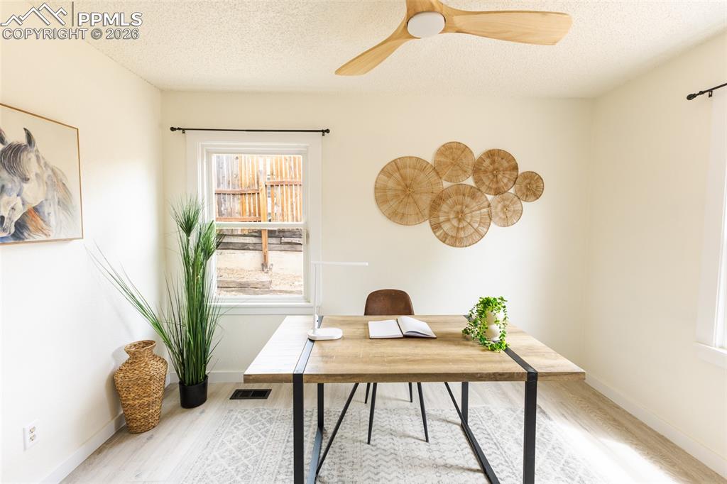 Image 17 of 24: Well-lit room featuring light wood-finish flooring, a white window frame, a