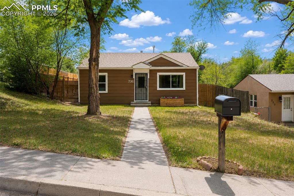 Image 2 of 24: Brown exterior siding with white trim, a gabled roof, and a front walkway