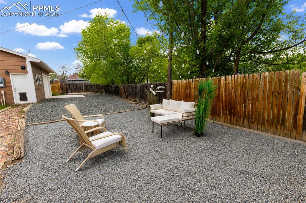 Image 22 of 24: Outdoor living area in backyard