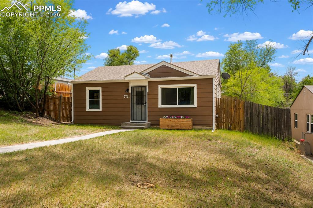 Image 3 of 24: Single-story home featuring brown horizontal siding and white trim