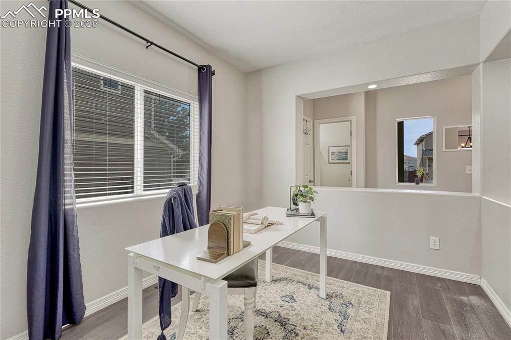 Image 10 of 50: Back inside, view of the main level office and half bath located near the e