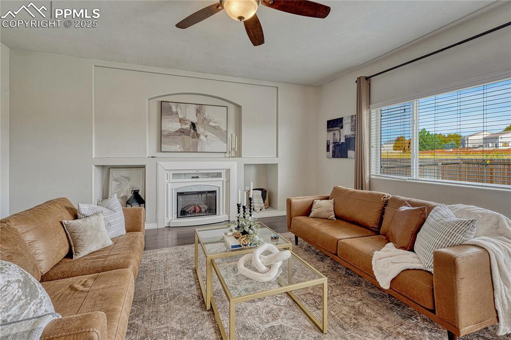 Image 19 of 50: Bright living room with neutral paint and a fireplace