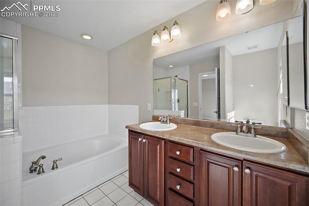 Image 30 of 50: Large soaking tub with stand alone shower. 