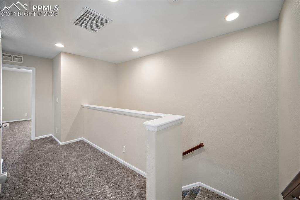 Image 35 of 50: Hallway on the upper level with new carpet. 