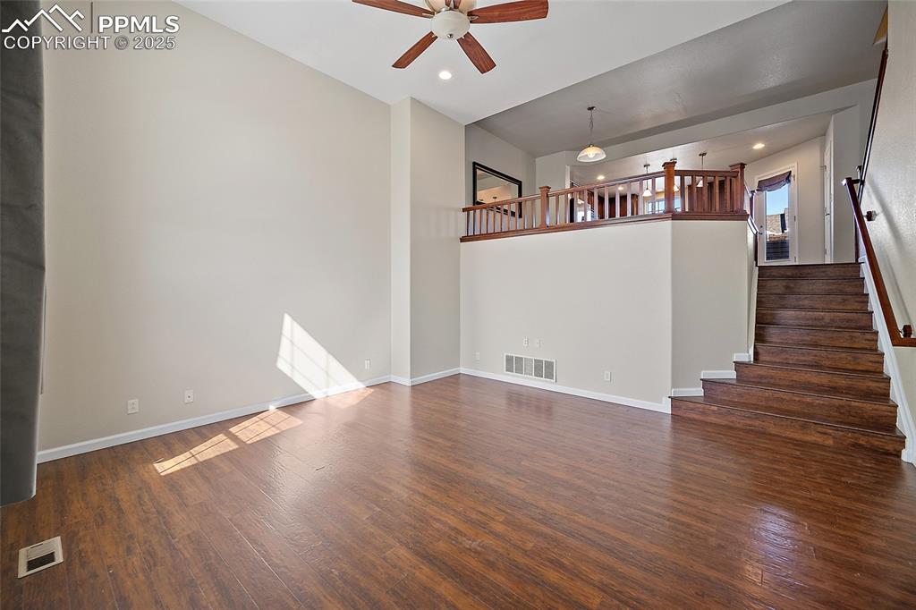 Image 6 of 50: Large Great room with soaring ceilings and luxury vinyl flooring. 