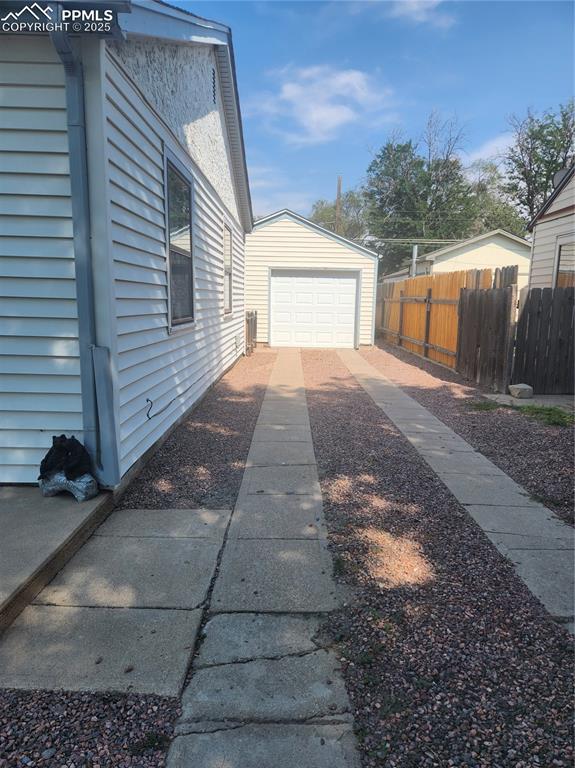 Image 10 of 10: View of property exterior with driveway and a garage