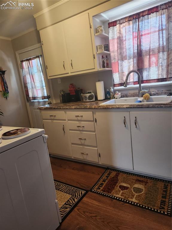 Image 4 of 10: Kitchen featuring open shelves, dark wood-style floors, stove, plenty of na