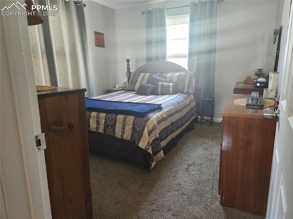Image 7 of 10: Bedroom featuring dark colored carpet
