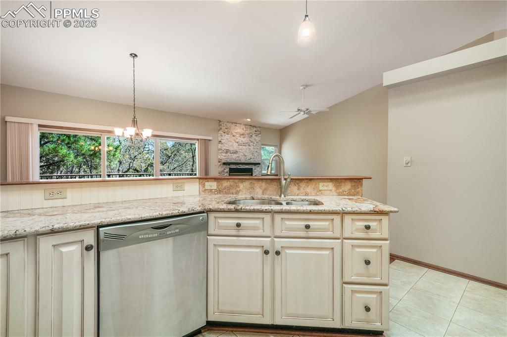 Image 14 of 50: Kitchen with additional bar seating, hard wood floors, updated appliances a
