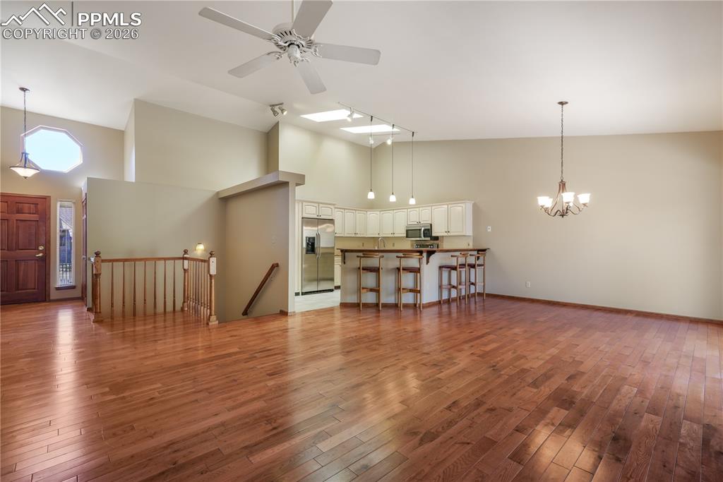 Image 21 of 50: Overview of living room, dining area and kitchen with views of entry and st