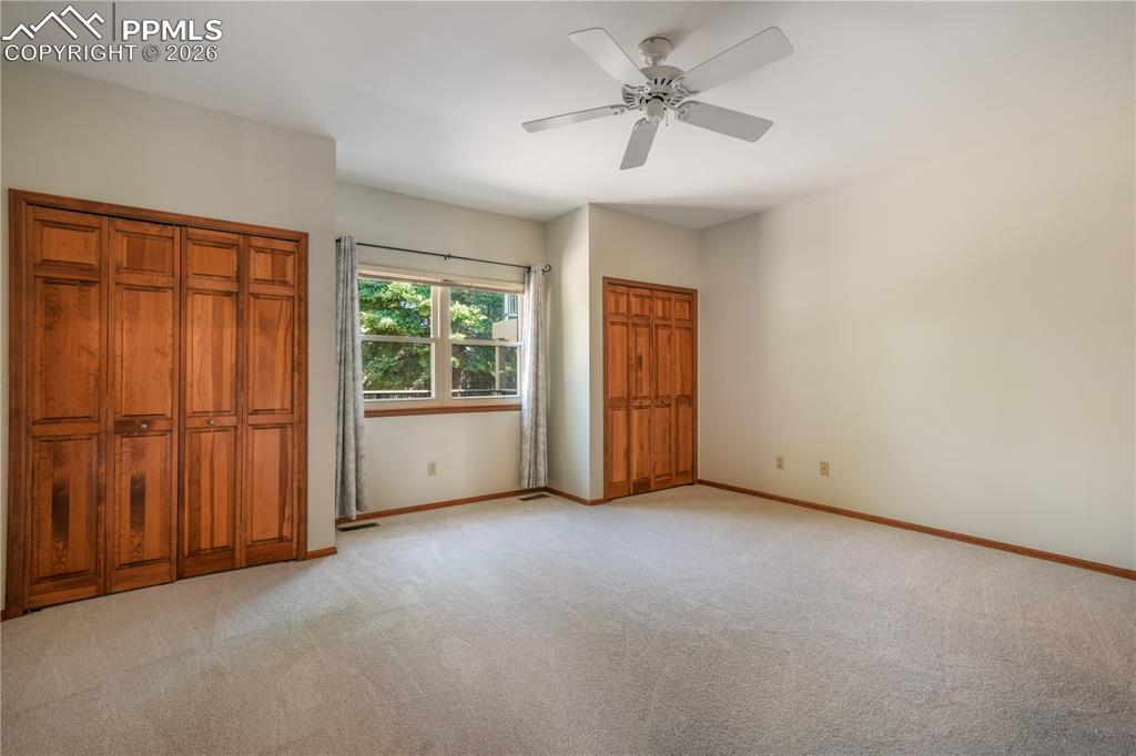 Image 22 of 50: Main level primary bedroom with new carpet, ensuite 5 piece bathroom, walk 