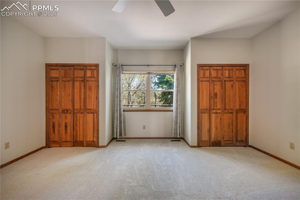 Image 23 of 50: Main level primary bedroom with new carpet, ensuite 5 piece bathroom, walk