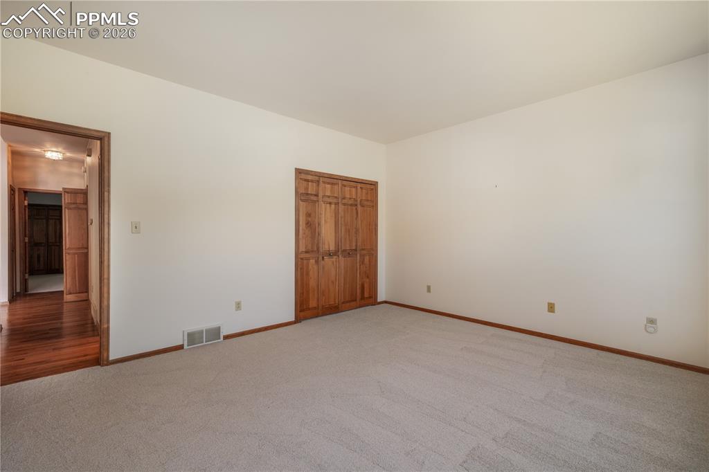 Image 28 of 50: Main floor 2nd bedroom with new carpet