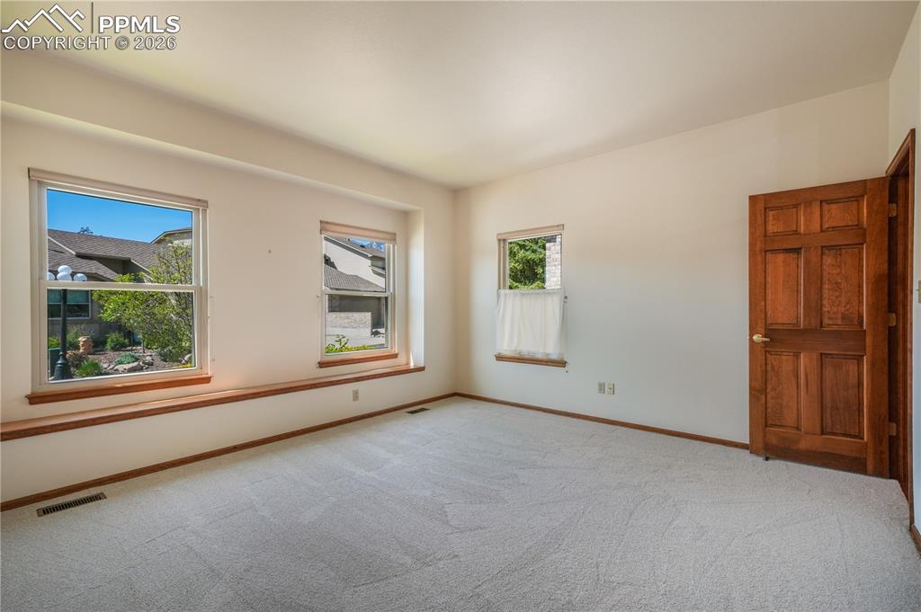 Image 29 of 50: Main floor 2nd bedroom with new carpet