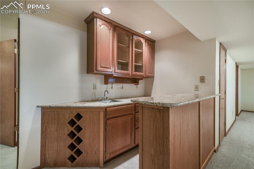 Image 32 of 50: Basement mini bar, refrigerator included, granite countertops