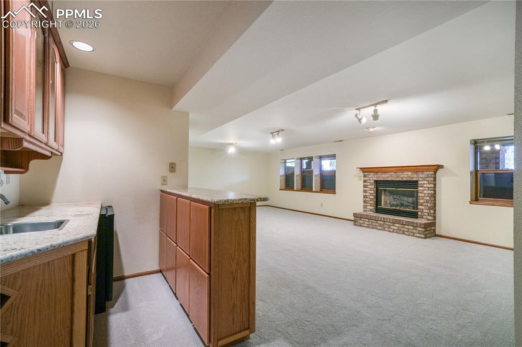 Image 33 of 50: Basement mini bar, refrigerator included, granite countertops