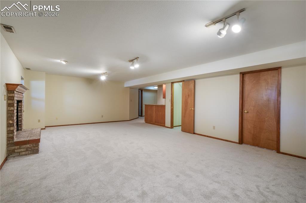Image 36 of 50: Basement family room, new carpet, views of storage room