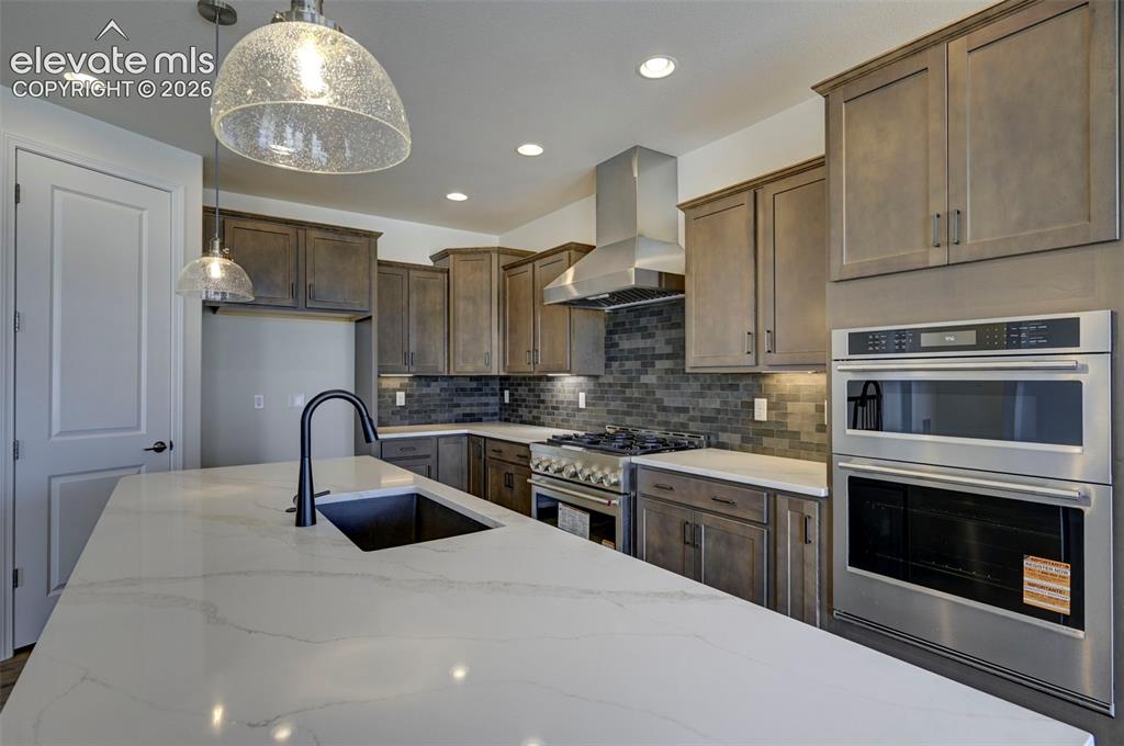 Image 18 of 35: 36" commercial gas range with external stainless vent hood, wall-in convect