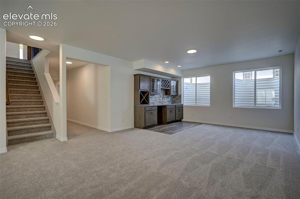 Image 28 of 35: finished basement with wine bar