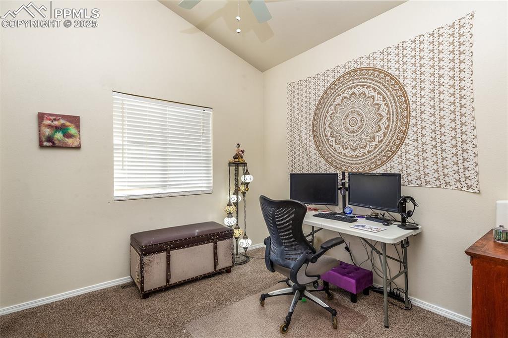 Image 4 of 12: Office area with baseboards, lofted ceiling, ceiling fan, and carpet