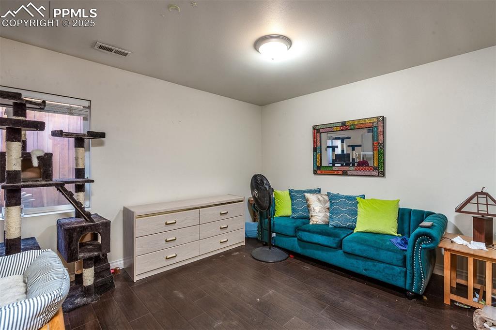 Image 5 of 12: Living area with visible vents and wood finished floors