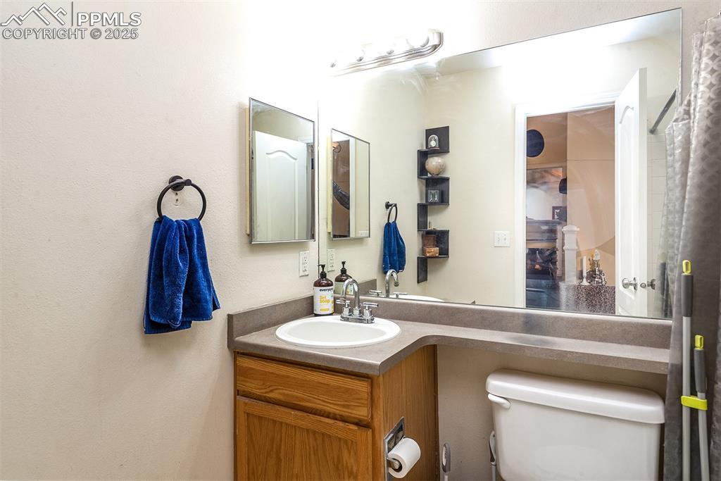 Image 7 of 12: Bathroom featuring toilet and vanity