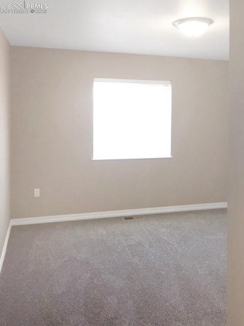 Image 10 of 19: Empty room featuring light carpet and baseboards