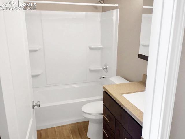Image 11 of 19: Full bath with vanity, shower / tub combination, and wood finish floors