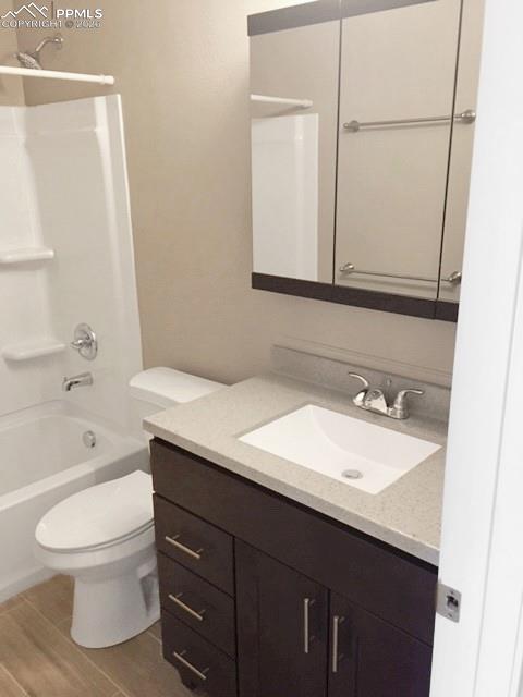 Image 12 of 19: Full bath featuring vanity, shower / bathtub combination, and light wood fi