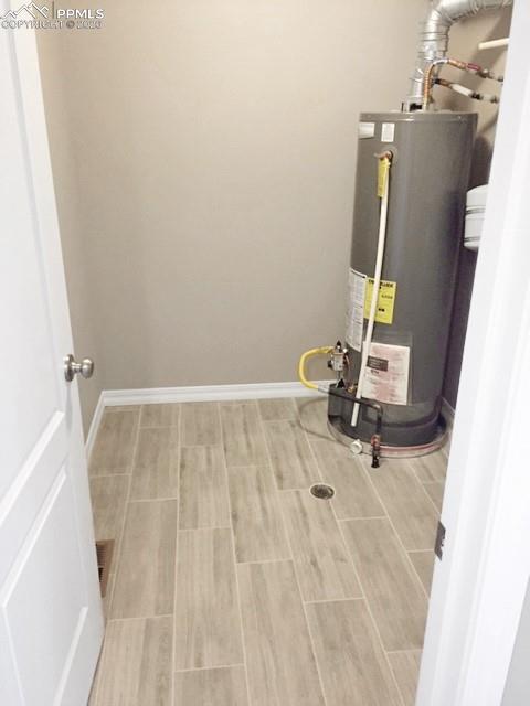 Image 14 of 19: Laundry room with gas water heater