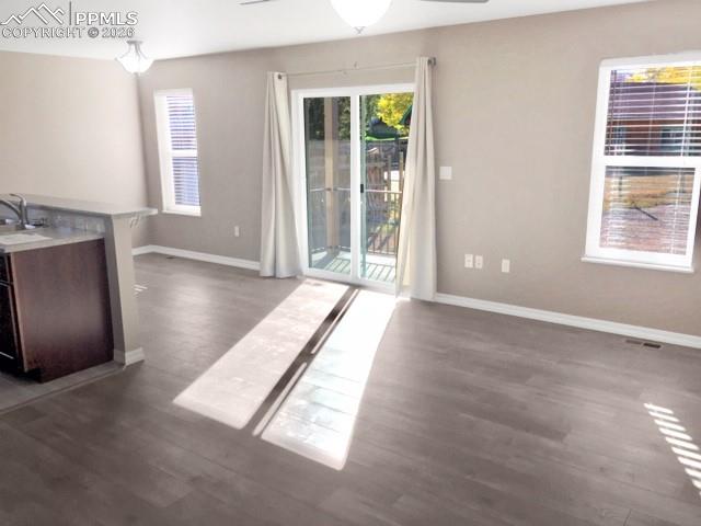 Image 4 of 19: dining area with plenty of natural light, ceiling fan, and dark wood-type f