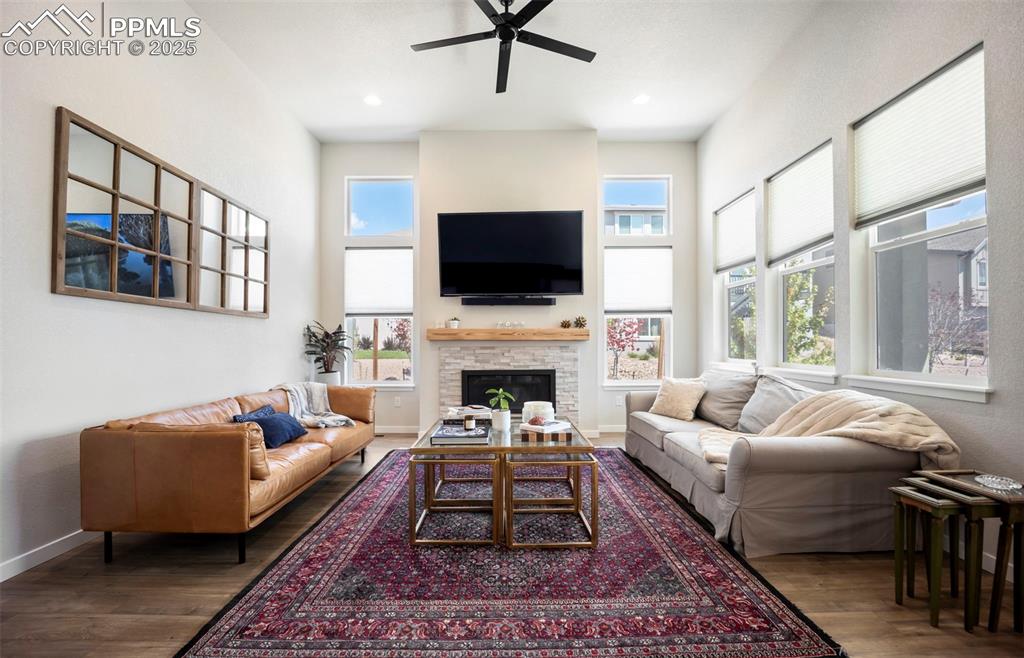 Image 19 of 50: Living room with custom mantle & upgraded ceiling fan