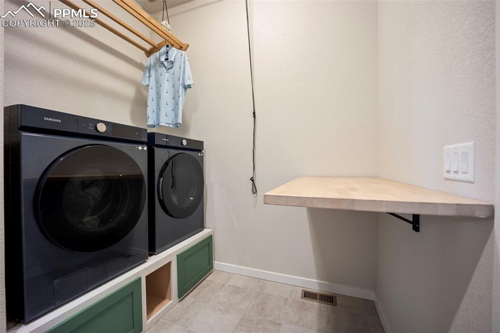 Image 28 of 50: custom built-in pulley system for hanging clothes