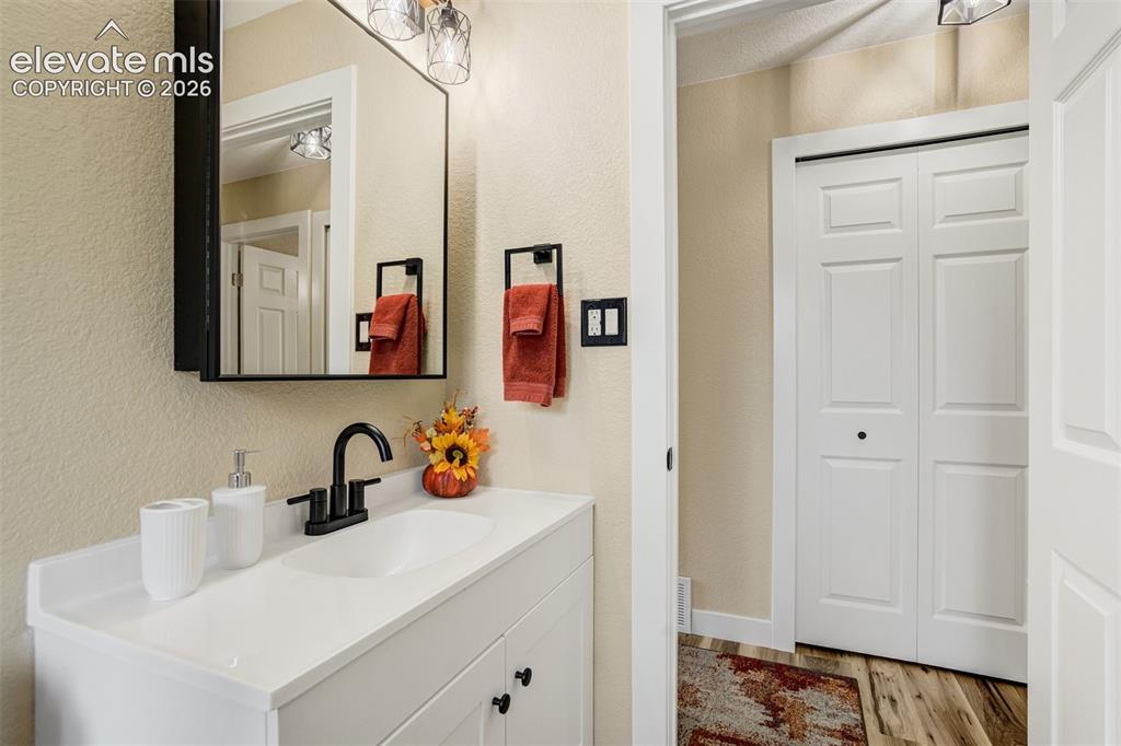 Image 27 of 50: Large vanity with linen closet across the hall