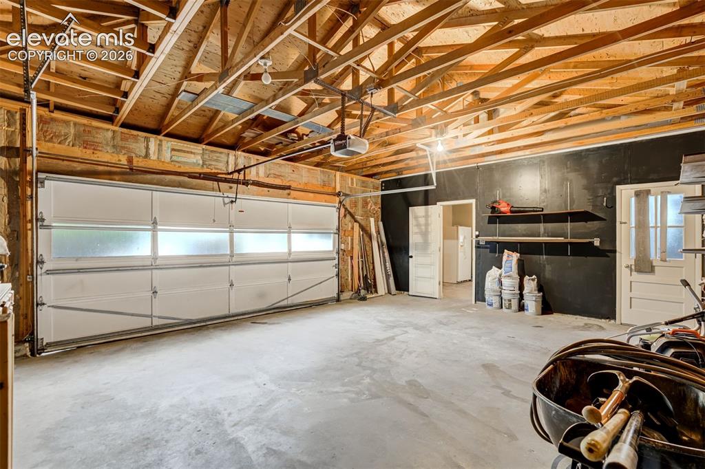 Image 44 of 50: First garage leads to the oversized two car garage with door to the yard