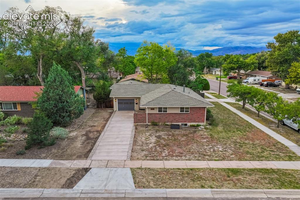 Image 6 of 50: Extended front driveway with access to one car garage.