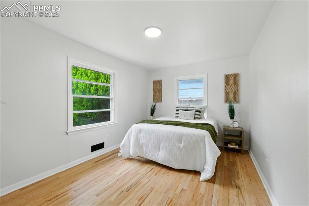 Image 14 of 32: Bedroom featuring wood finished floors and baseboards