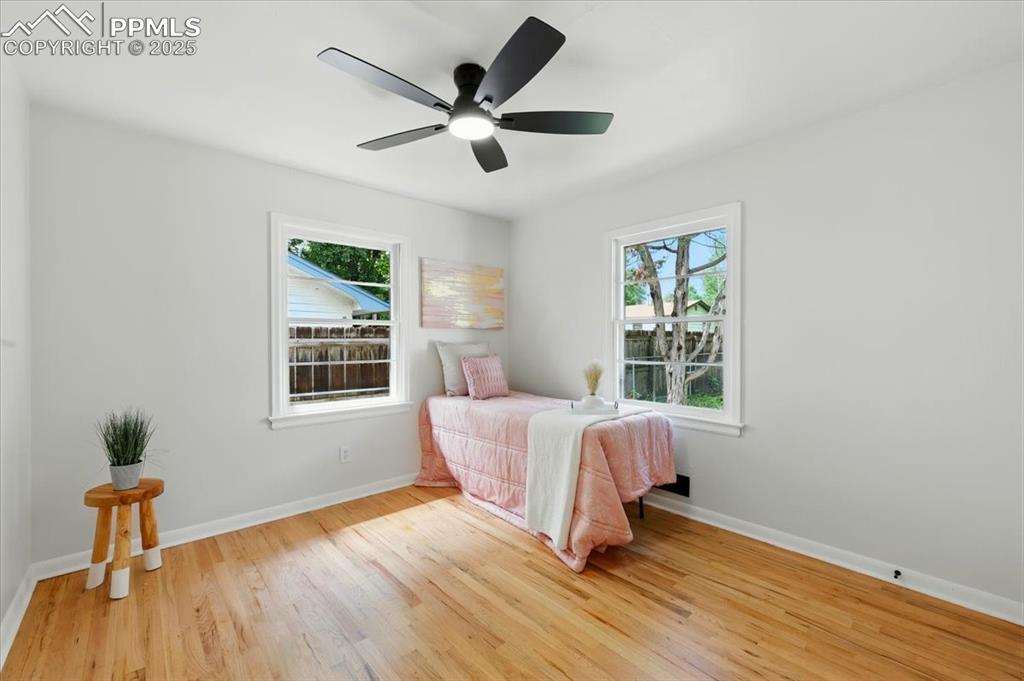 Image 16 of 32: Bedroom featuring multiple windows, light wood-style floors, and a ceiling