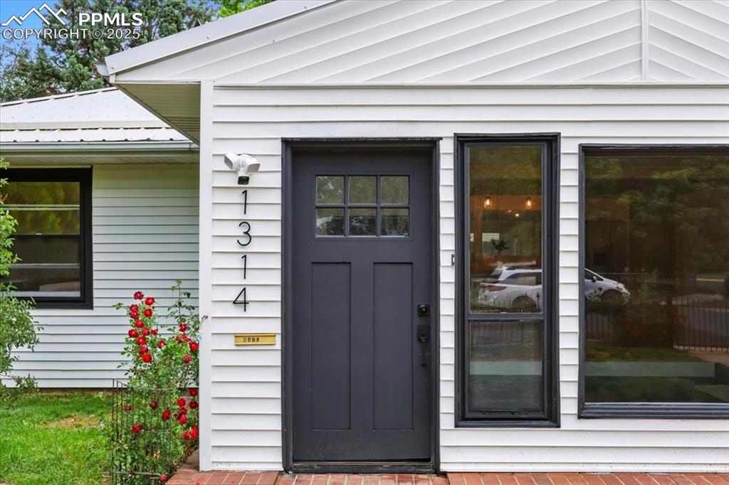 Image 2 of 32: View of exterior entry featuring a metal roof