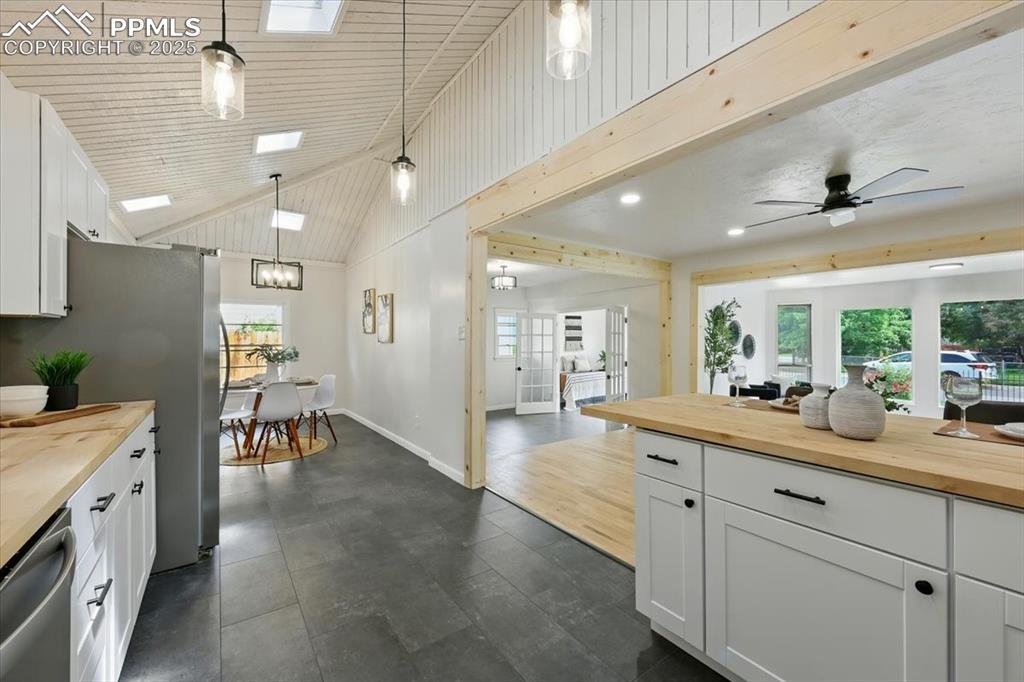 Image 24 of 32: Kitchen with wooden counters, stainless steel appliances, healthy amount of