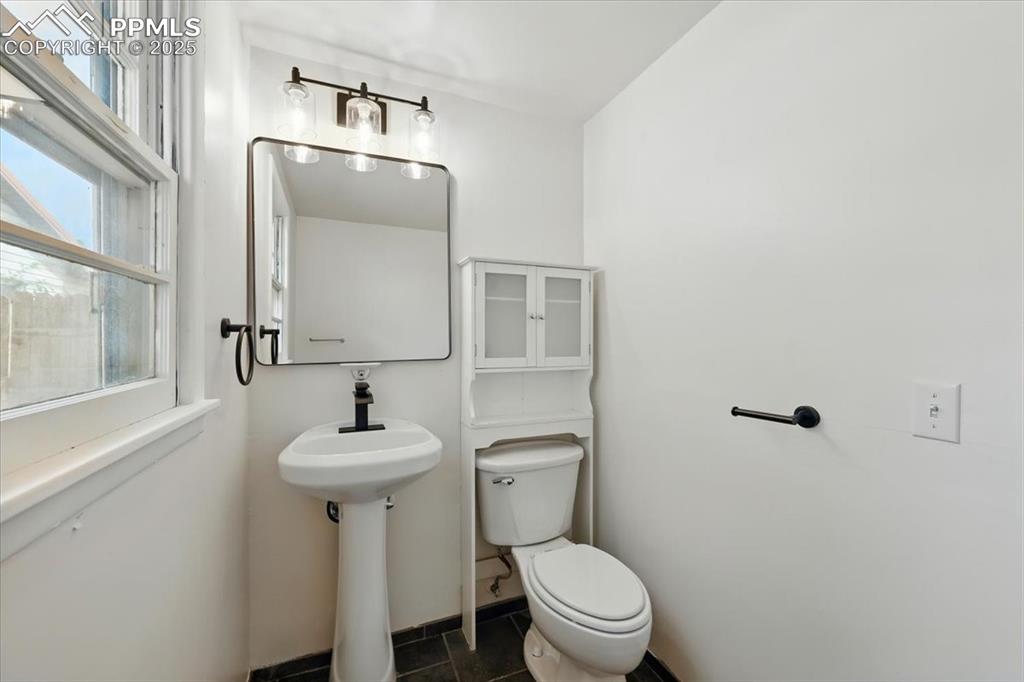 Image 29 of 32: Bathroom featuring toilet and tile patterned flooring