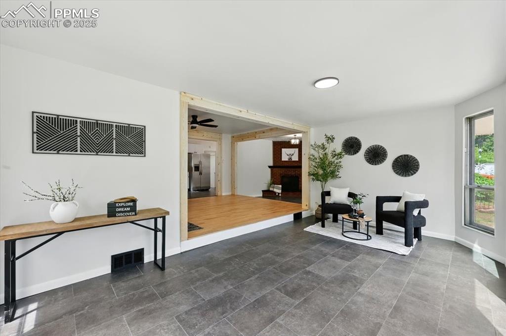 Image 4 of 32: Sitting room with baseboards and a fireplace