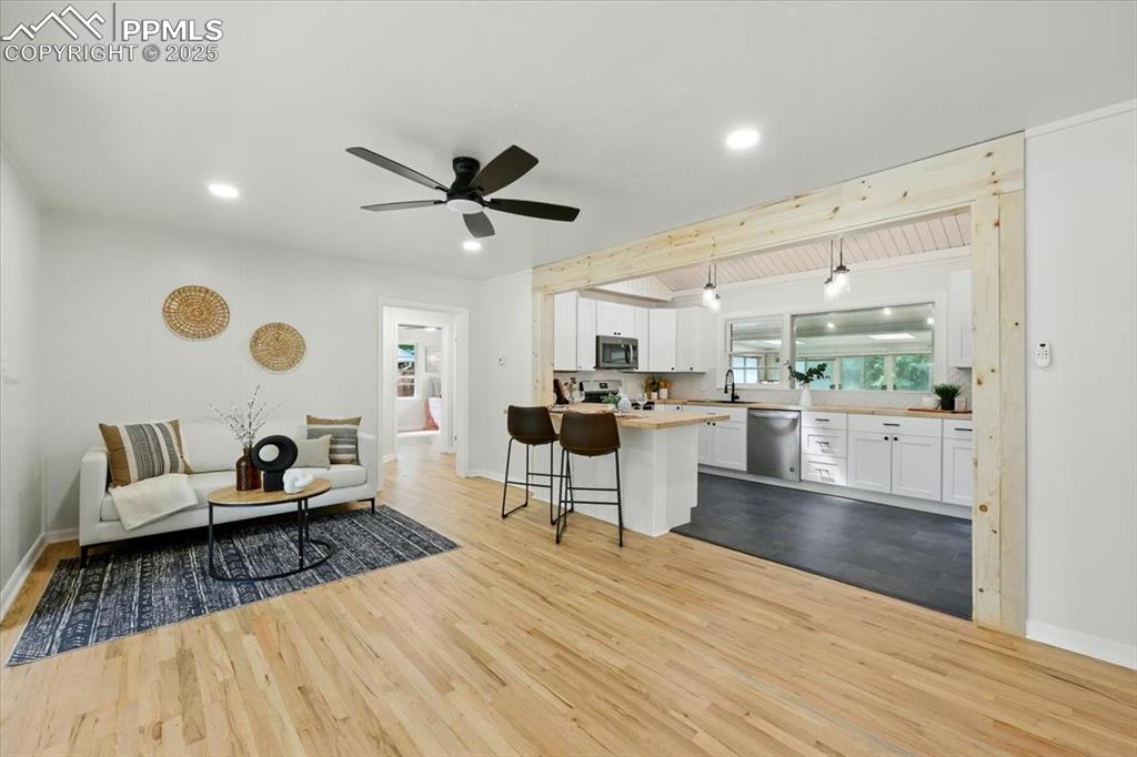 Image 5 of 32: Living area featuring wood finished floors, recessed lighting, and a ceilin