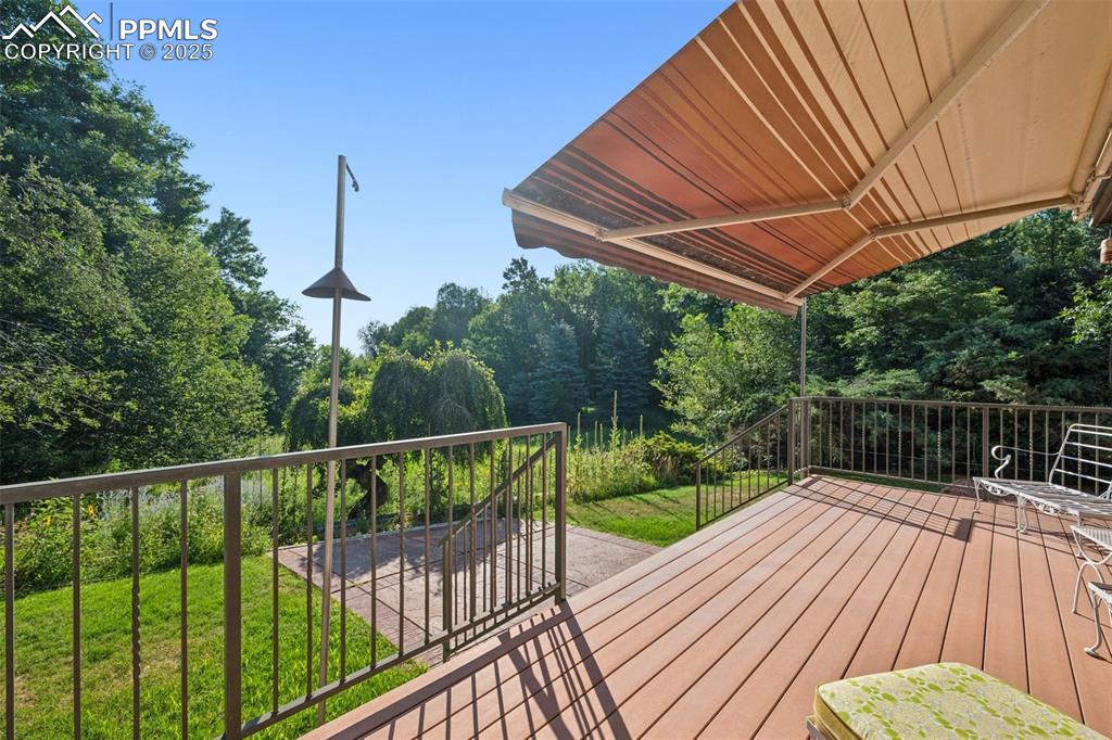 Image 25 of 49: Awning over deck for warm afternoons