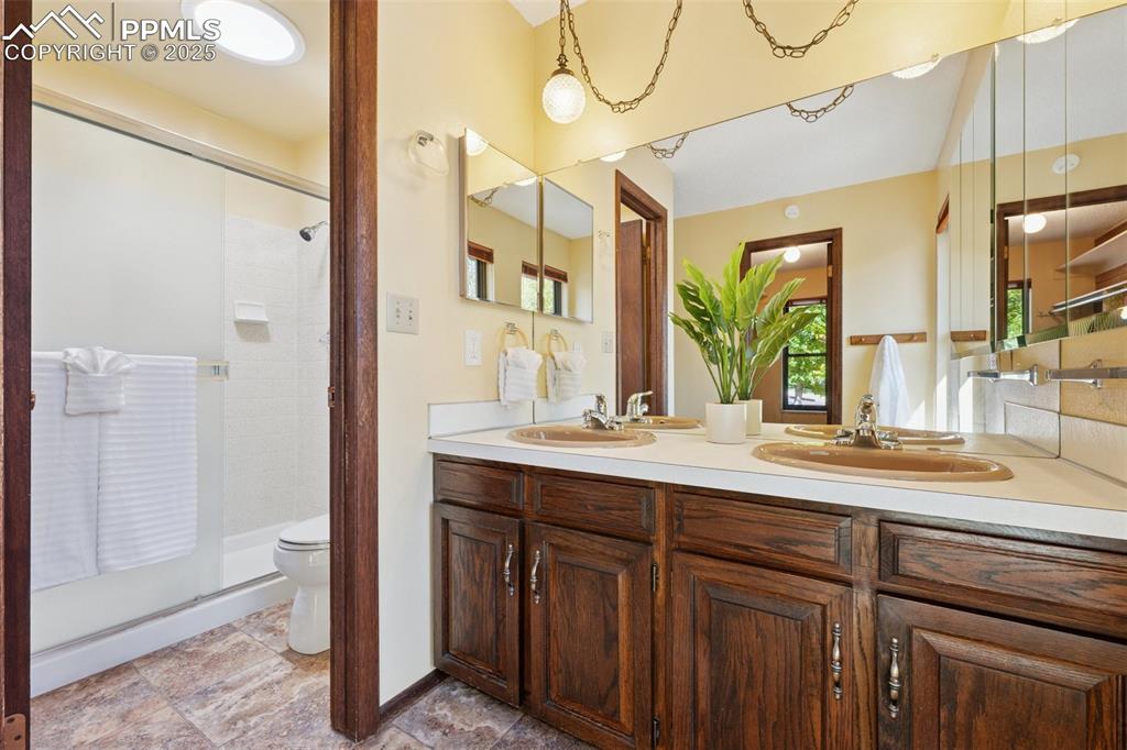 Image 28 of 49: Master bath includes a large walk in closet with window