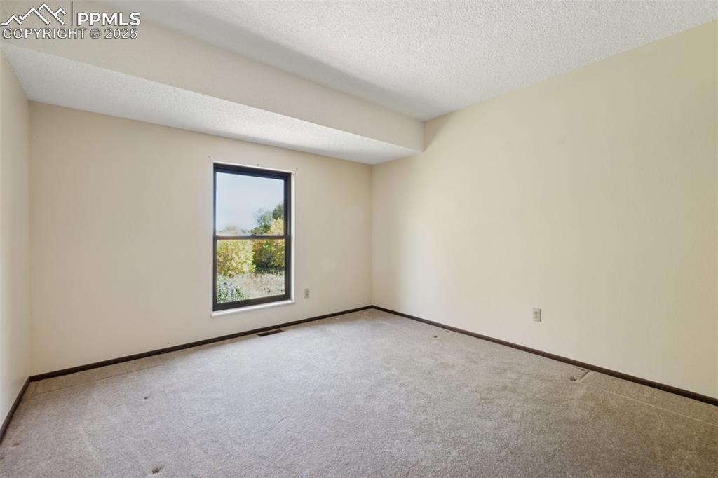 Image 29 of 49: Bedroom 2 with open space views