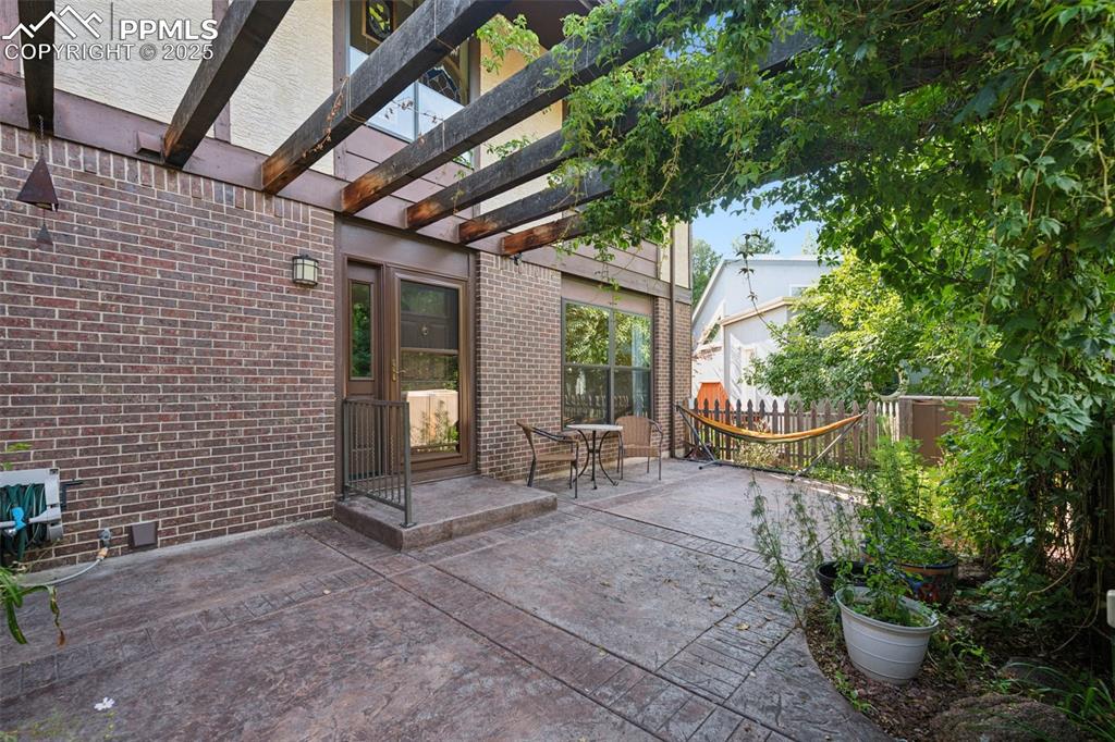 Image 7 of 49: Private front patio with arbor and new front door