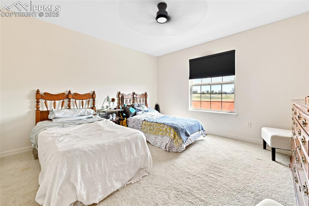 Image 14 of 22: Bedroom featuring light colored carpet and ceiling fan