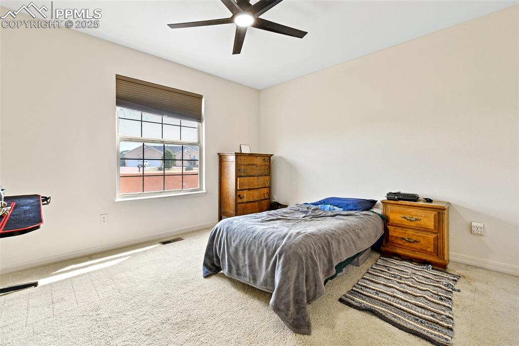 Image 15 of 22: Carpeted bedroom featuring baseboards and a ceiling fan